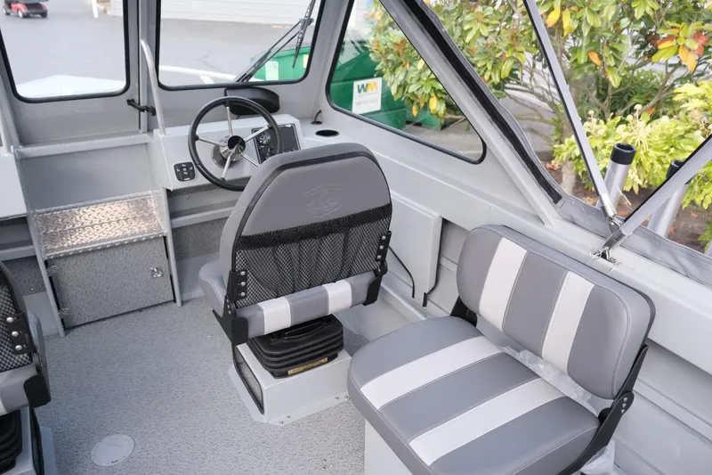 Slide: The Image of 2024 Hewescraft 180 Pro-V ET boat interior with gray seating and steering wheel. - 13