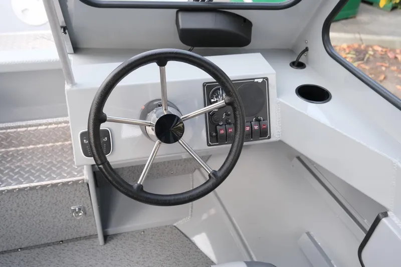 Slide: The Image of 2024 Hewescraft 180 Pro-V ET boat interior with steering wheel and control panel. - 15