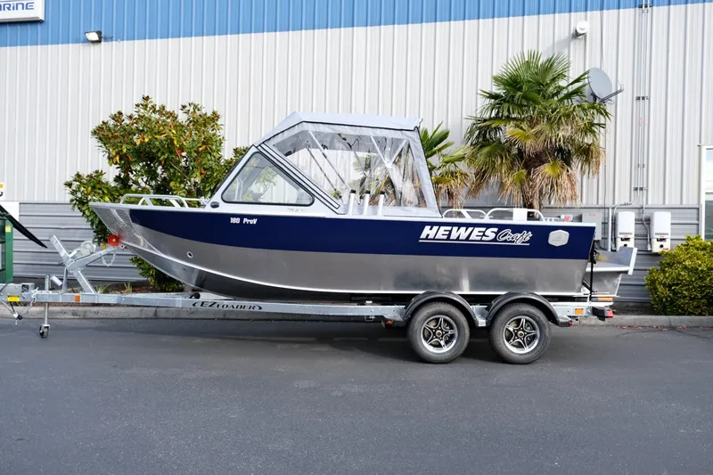 The Image of 2024 Hewescraft 180 Pro-V ET boat on trailer, parked outdoors. - 2