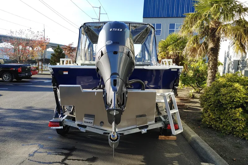 Slide: The Image of 2024 Hewescraft 180 Pro-V ET boat with powerful outboard motor, parked outdoors. - 6