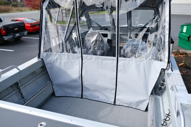 Slide: The Image of 2024 Hewescraft 180 Pro-V ET boat with covered seating area in a parking lot. - 9