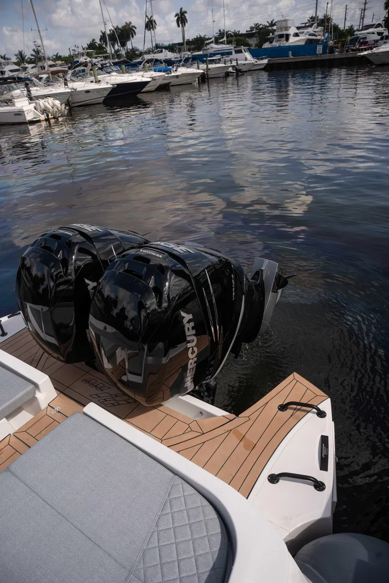 Slide: The Image of 2025 Panamera Yacht PY 100 with dual Mercury outboard engines docked at marina. - 10