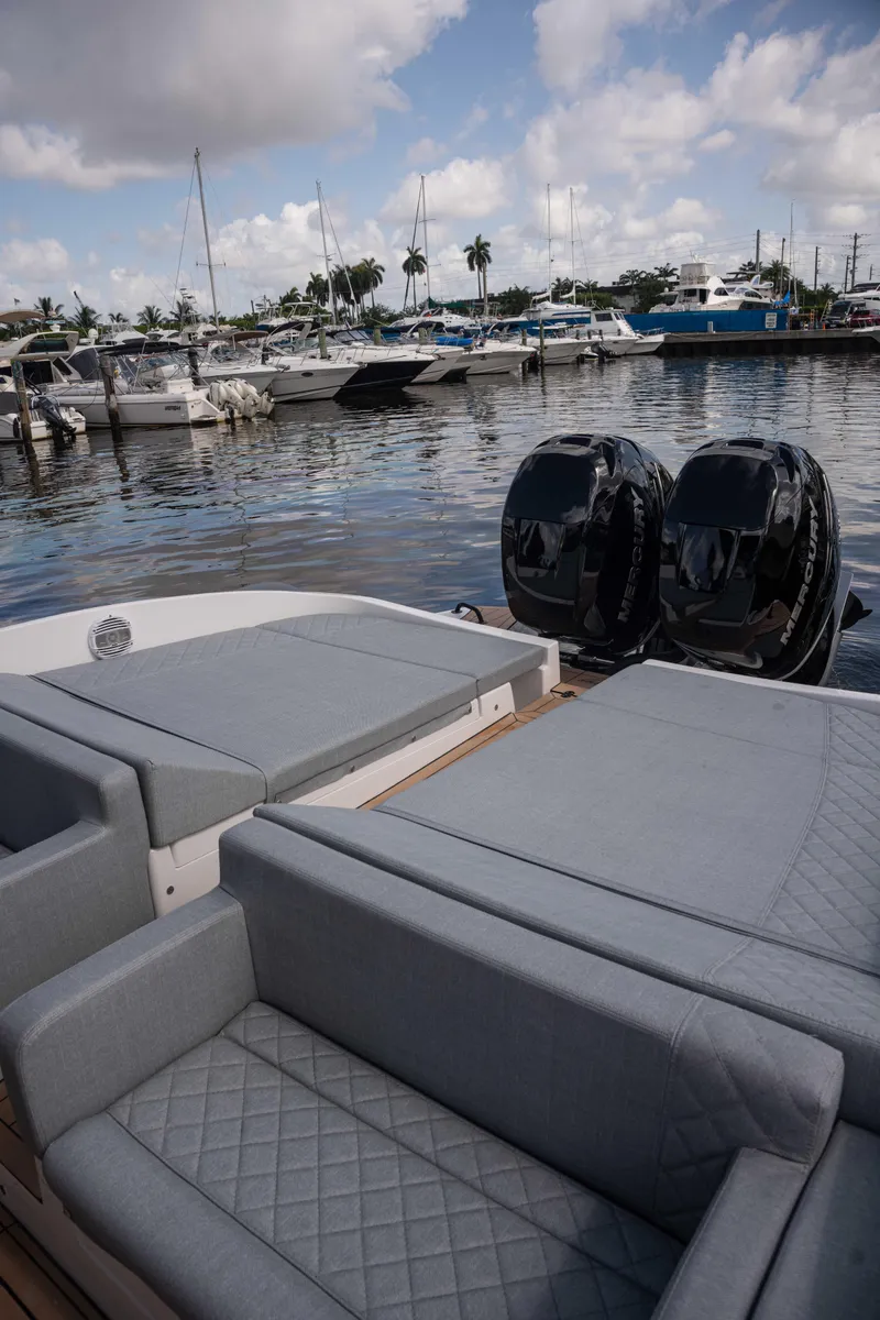 Slide: The Image of 2025 Panamera Yacht PY 100 at a marina with luxurious seating and twin outboard motors. - 8