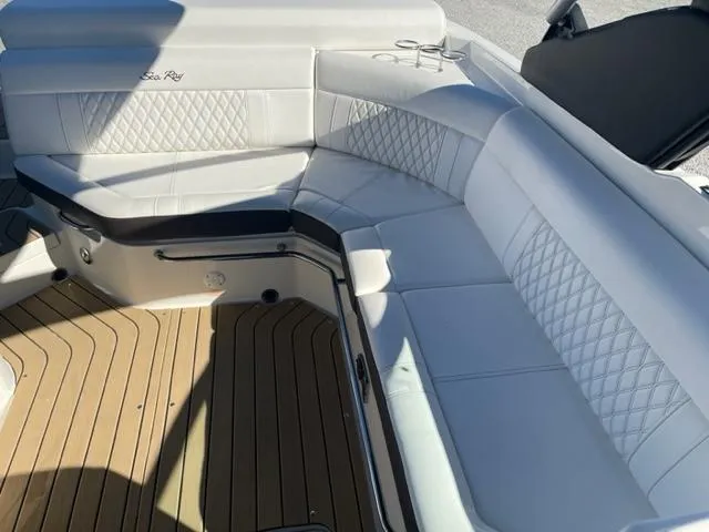 Slide: The Image of 2022 Sea Ray SLX 280 boat interior with white leather seating and teak flooring. - 11