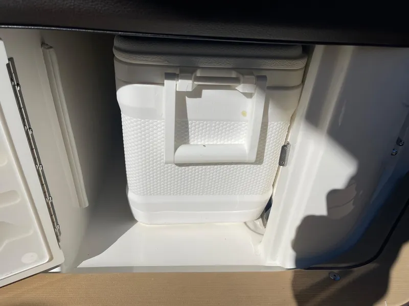 Slide: The Image of White cooler inside 2022 Sea Ray SLX 280 storage compartment. - 7