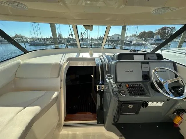 Slide: The Image of 2012 Pursuit OS 375 Offshore boat helm with Garmin navigation system. - 13