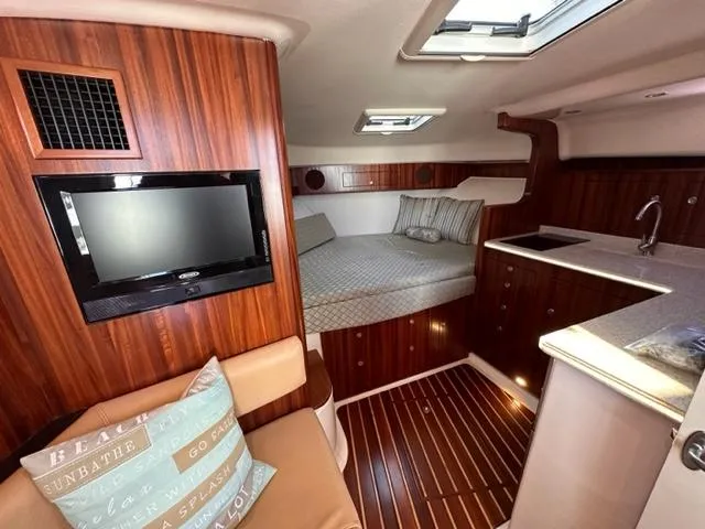 Slide: The Image of Interior of 2012 Pursuit OS 375 Offshore boat with bed, TV, and kitchenette. - 14