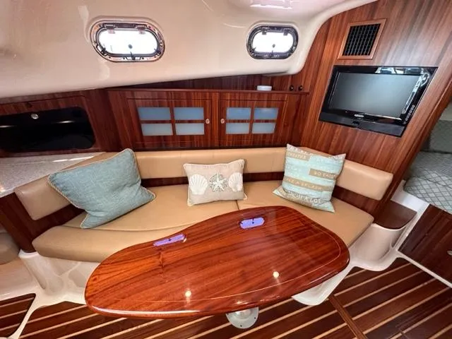 Slide: The Image of Luxurious interior of 2012 Pursuit OS 375 Offshore with wood finishes and cozy seating. - 18
