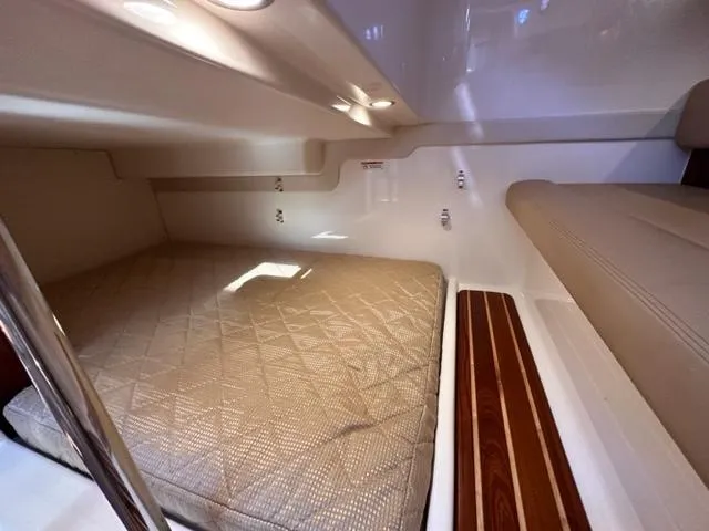 Slide: The Image of 2012 Pursuit OS 375 Offshore cabin interior with bed and seating area. - 19
