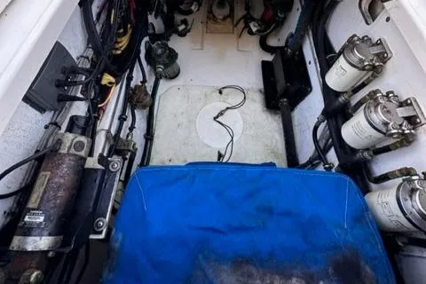 Slide: The Image of 2012 Pursuit OS 375 Offshore engine compartment with various mechanical components. - 26