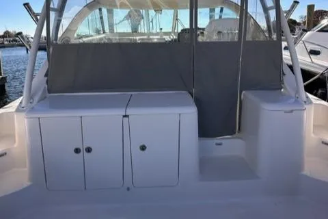 Slide: The Image of 2012 Pursuit OS 375 Offshore boat cockpit with storage compartments and seating. - 27