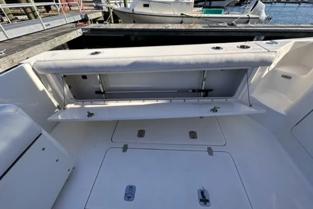 Slide: The Image of 2012 Pursuit OS 375 Offshore boat interior with open storage compartment. - 28