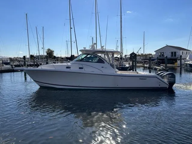 Slide: The Image of 2012 Pursuit OS 375 Offshore boat docked in a marina. - 3