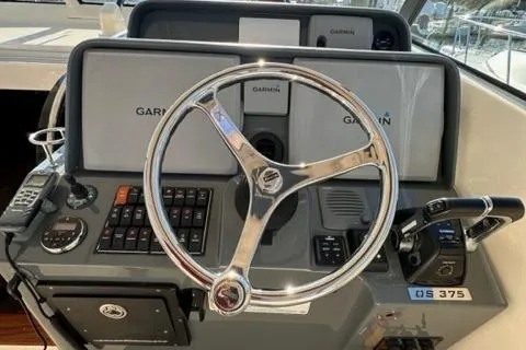 Slide: The Image of 2012 Pursuit OS 375 Offshore boat helm with Garmin navigation system. - 30