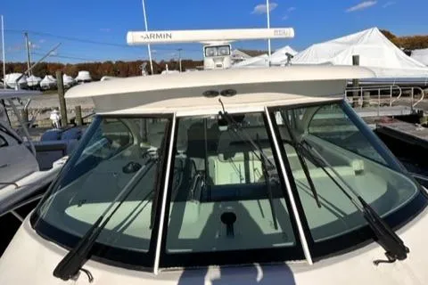 Slide: The Image of 2012 Pursuit OS 375 Offshore boat with Garmin radar, docked at a marina. - 37