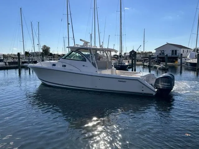 Slide: The Image of 2012 Pursuit OS 375 Offshore boat docked in a marina. - 4