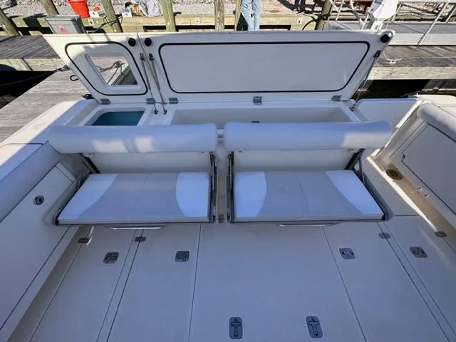 Slide: The Image of 2012 Pursuit OS 375 Offshore boat with foldable seating and storage compartments. - 9