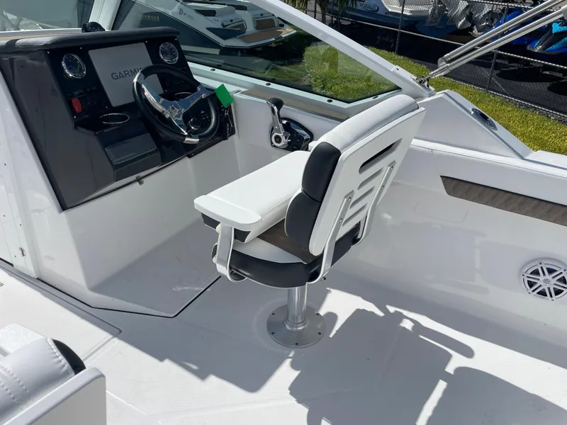 Slide: The Image of 2024 Blackfin 232DC boat cockpit with captain's chair and steering console. - 10