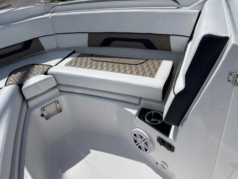 Slide: The Image of 2024 Blackfin 232DC boat interior with cushioned seating and speaker. - 14