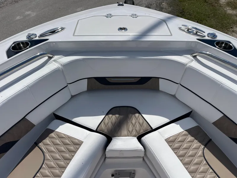 Slide: The Image of 2024 Blackfin 232DC boat with luxurious bow seating and cup holders. - 16