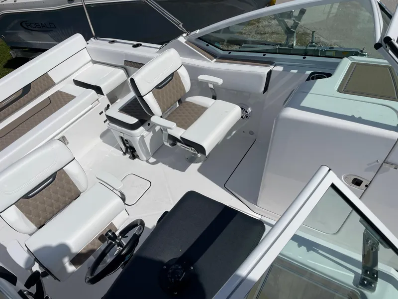 Slide: The Image of 2024 Blackfin 232DC boat interior with white and beige seating. - 20