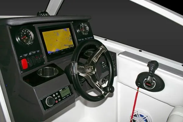 Slide: The Image of 2024 Blackfin 232DC boat dashboard with navigation screen and controls. - 44
