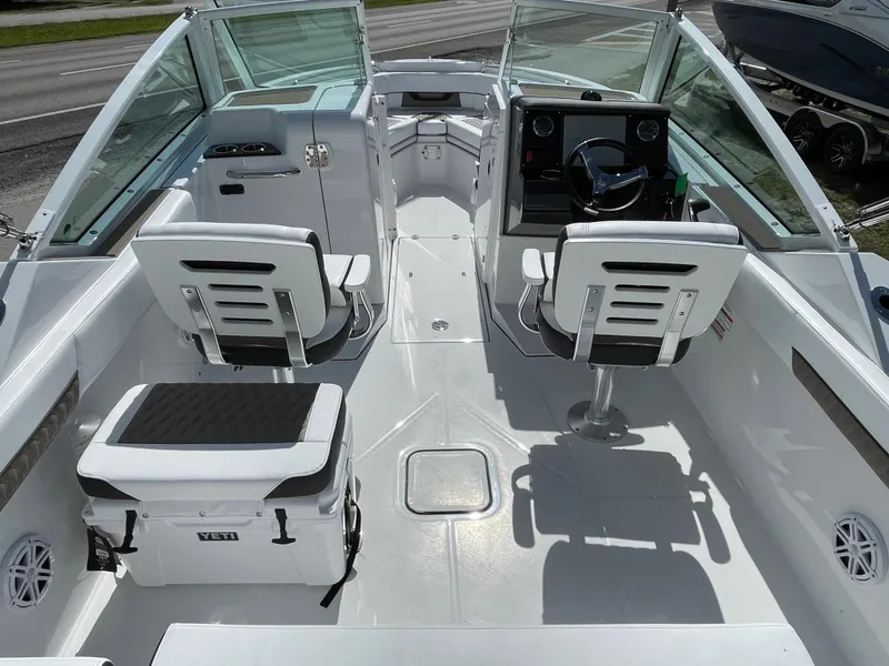 Slide: The Image of 2024 Blackfin 232DC boat interior with dual captain chairs and a Yeti cooler. - 5