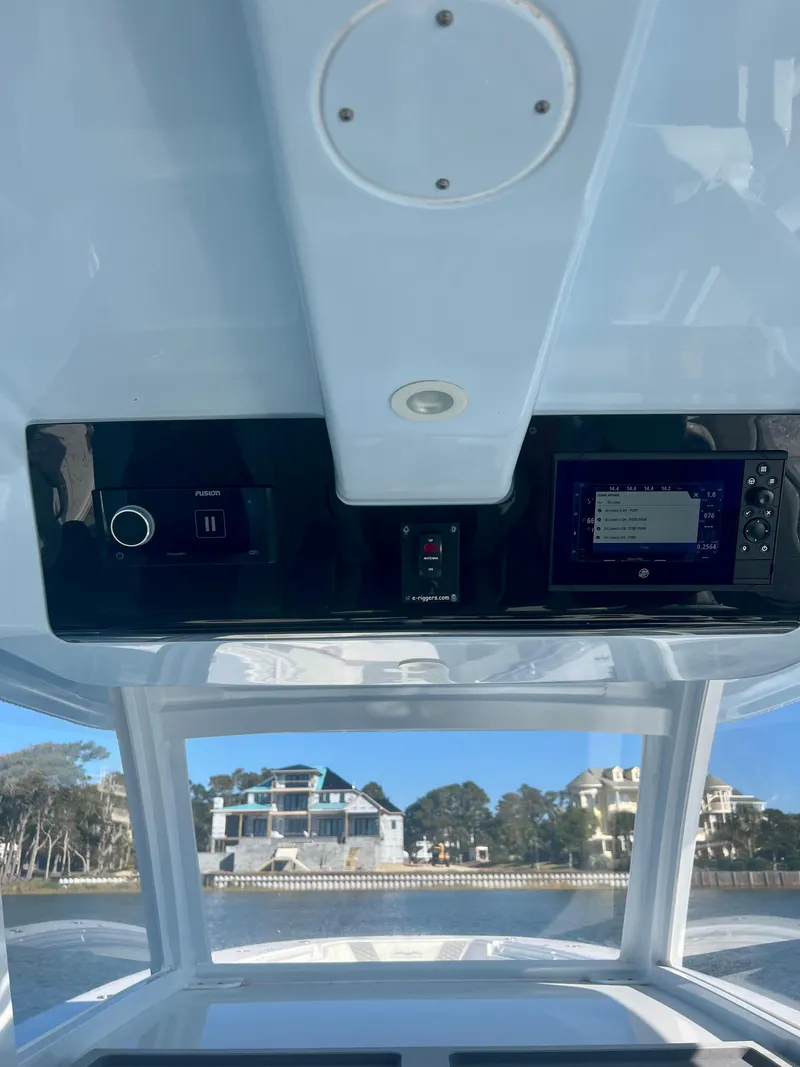 Slide: The Image of 2024 Invincible 43 Open Fisherman boat dashboard with navigation controls. - 11