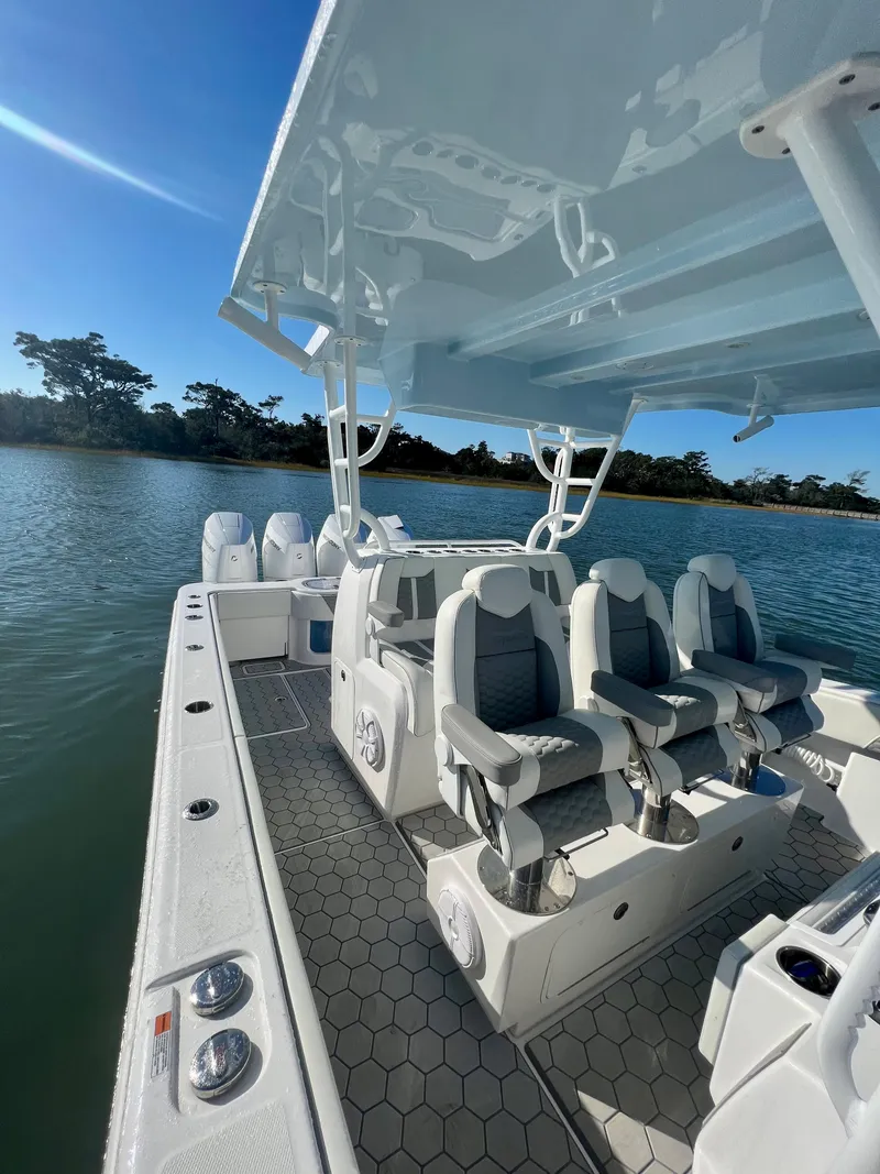 Slide: The Image of 2024 Invincible 43 Open Fisherman boat interior with seating and water view. - 18