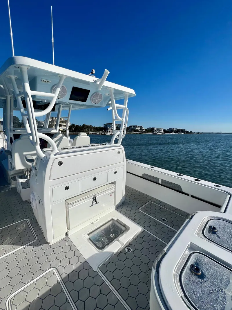 Slide: The Image of 2024 Invincible 43 Open Fisherman boat on water with clear blue sky. - 8