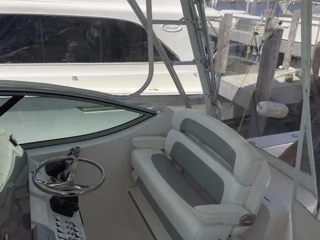 Slide: The Image of Interior helm of 2015 Stamas 390 Aegean boat with white seating and steering wheel. - 14