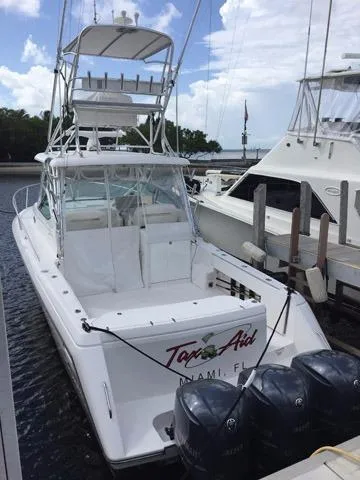 Slide: The Image of 2015 Stamas 390 Aegean boat docked at marina with triple outboard engines. - 17