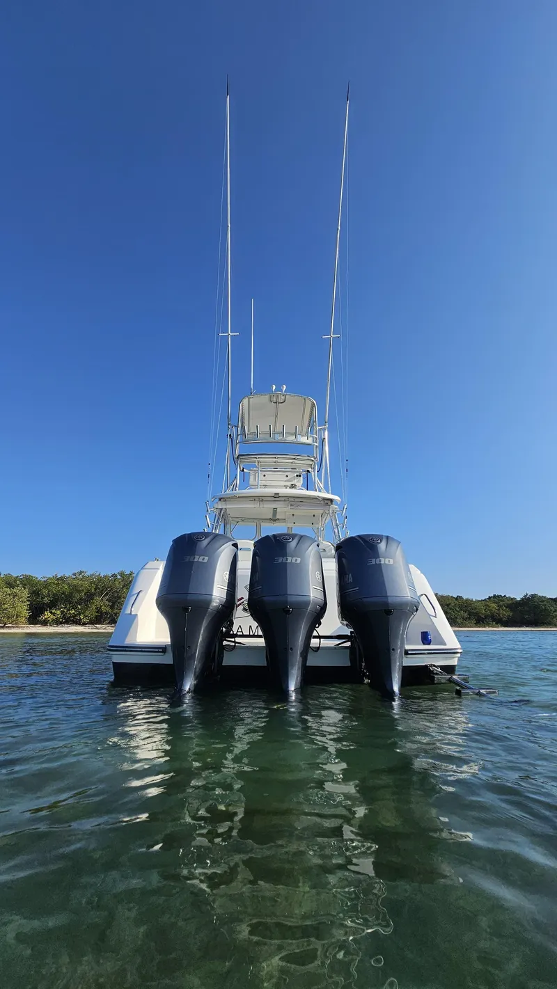 Slide: The Image of 2015 Stamas 390 Aegean boat with triple outboard motors on clear water. - 24