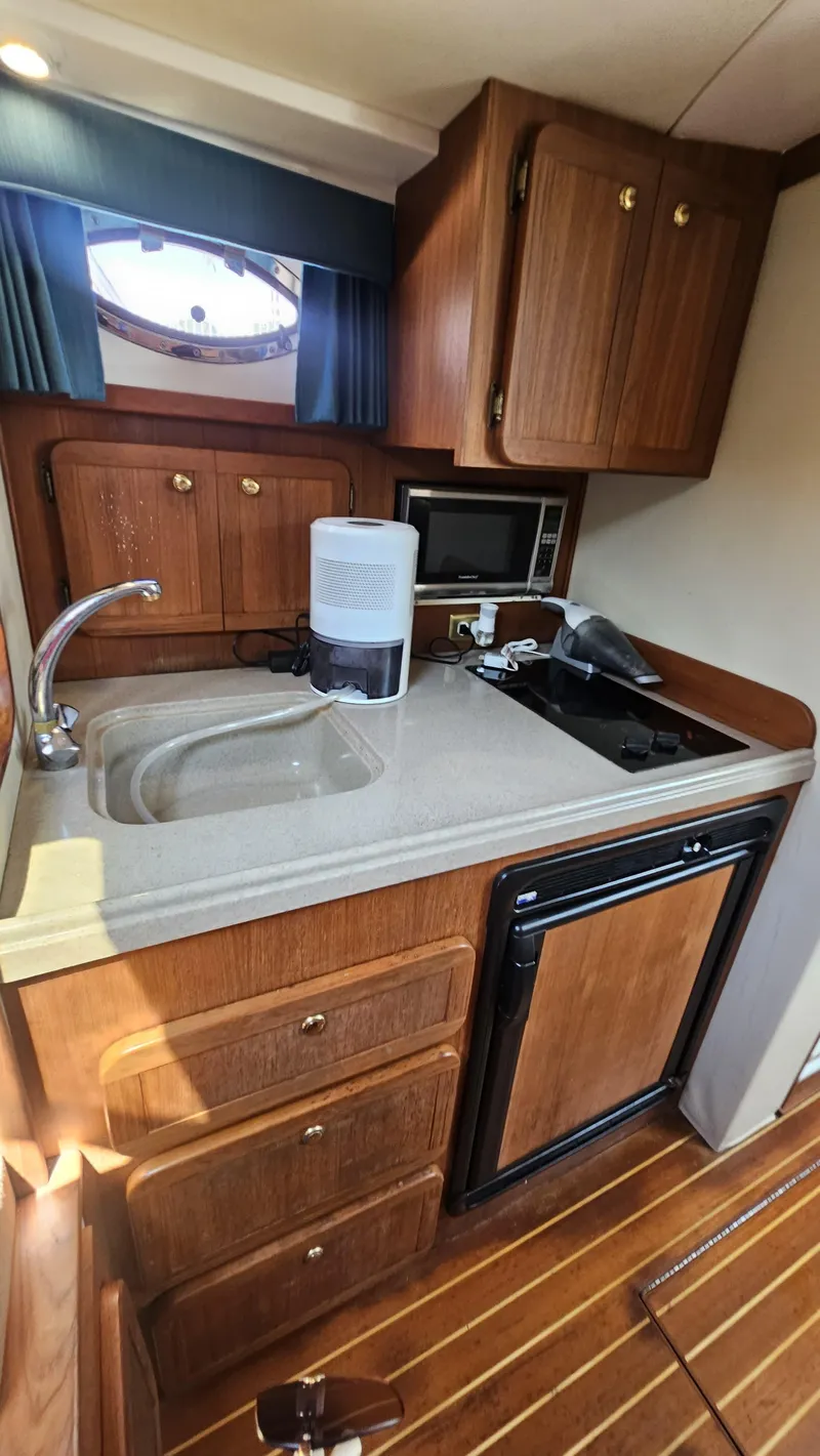 Slide: The Image of 2015 Stamas 390 Aegean yacht kitchen with wooden cabinets and modern appliances. - 25