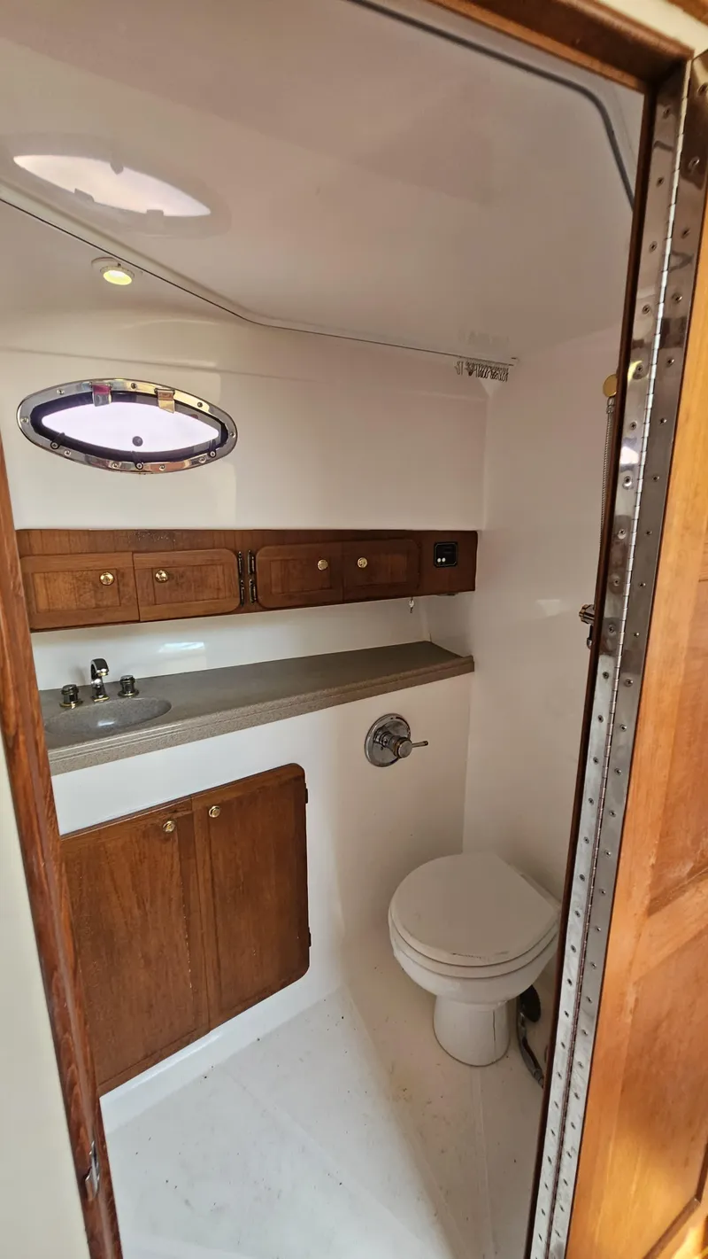 Slide: The Image of 2015 Stamas 390 Aegean boat bathroom with wooden cabinets and white fixtures. - 28