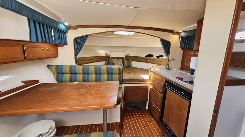 Slide: The Image of 2015 Stamas 390 Aegean boat interior with wood finishes and striped upholstery. - 30