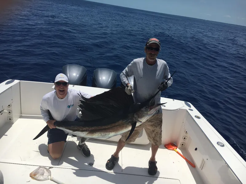 Slide: The Image of Two men holding a large sailfish on a 2015 Stamas 390 Aegean boat. - 35
