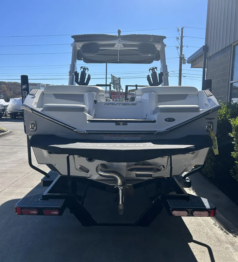 Slide: The Image of 2023 Nautique G25 boat rear view in a marina. - 3