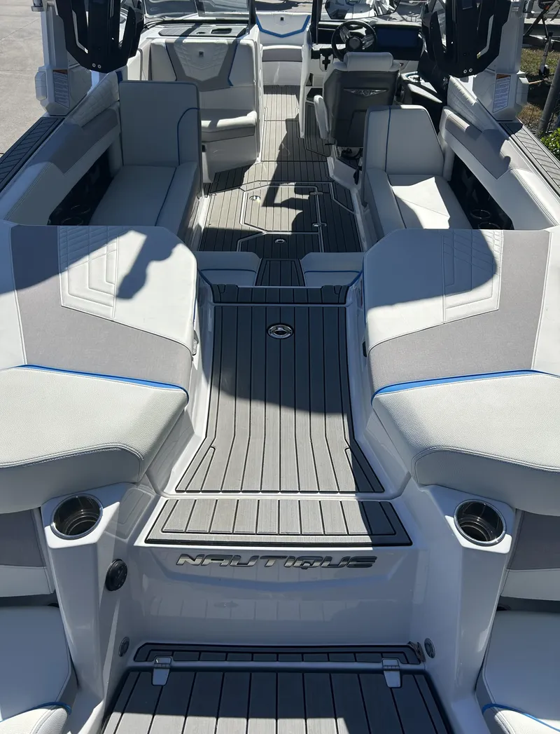 Slide: The Image of 2023 Nautique G25 boat interior with luxurious seating and modern design. - 6