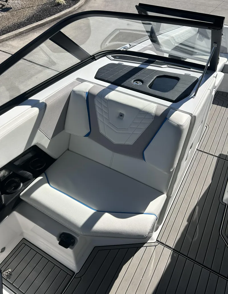 Slide: The Image of 2023 Nautique G25 boat interior with white seating and modern design. - 9