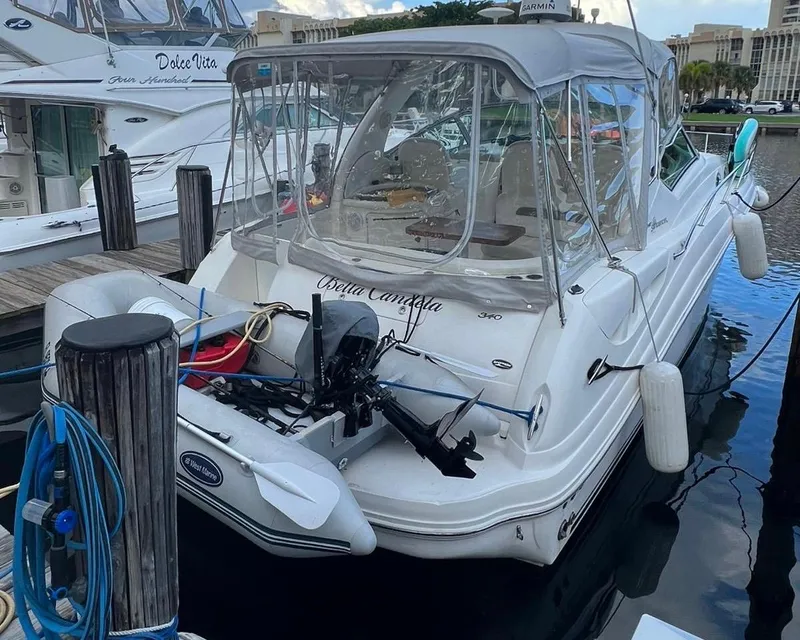 Slide: The Image of 2006 Sea Ray 340 Sundancer docked with clear canopy and attached dinghy. - 17