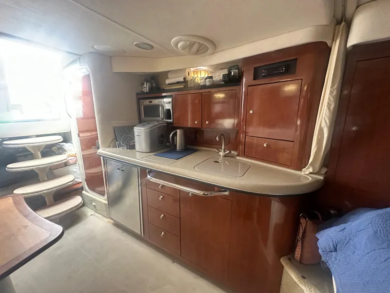 Slide: The Image of Interior of 2006 Sea Ray 340 Sundancer yacht with kitchen and storage cabinets. - 44