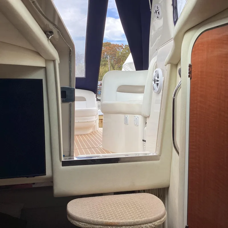 Slide: The Image of Interior view of 2005 Sea Ray 320 Sundancer yacht with seating and wood accents. - 13