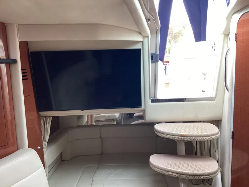 Slide: The Image of Interior of 2005 Sea Ray 320 Sundancer with TV and seating area. - 14
