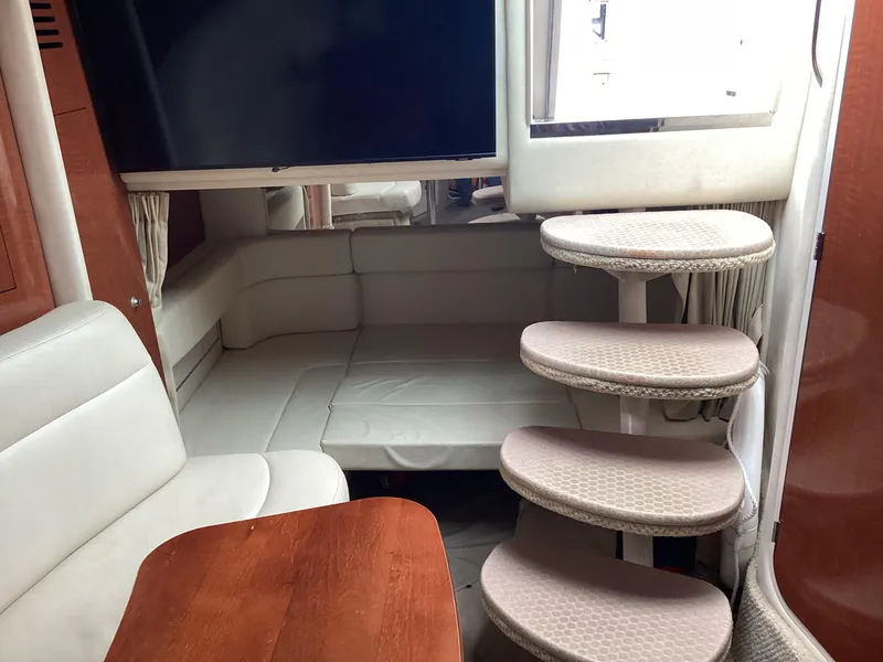 Slide: The Image of Interior of 2005 Sea Ray 320 Sundancer with seating, table, and spiral stairs. - 15