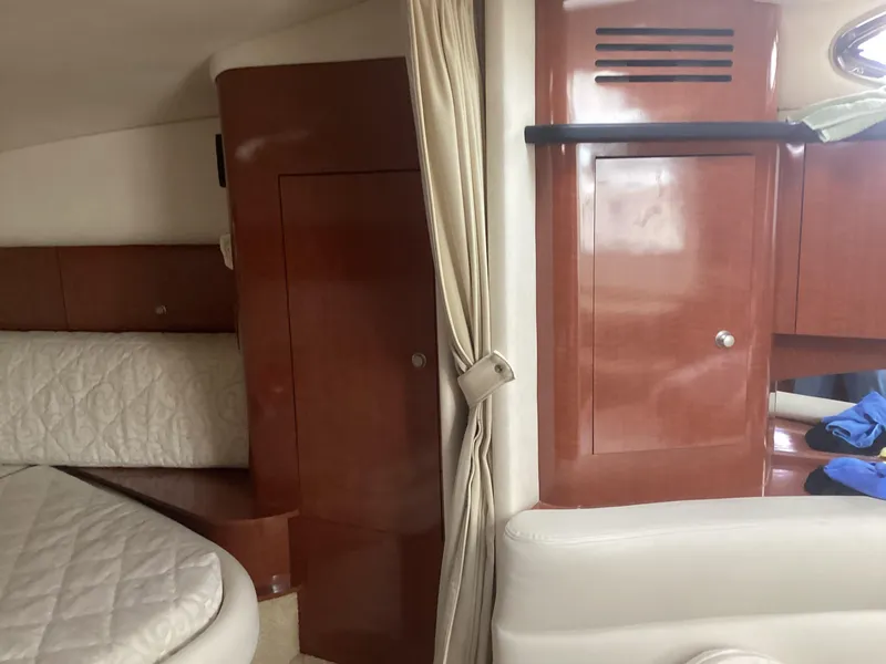 Slide: The Image of Interior of 2005 Sea Ray 320 Sundancer with wood cabinetry and white upholstery. - 20