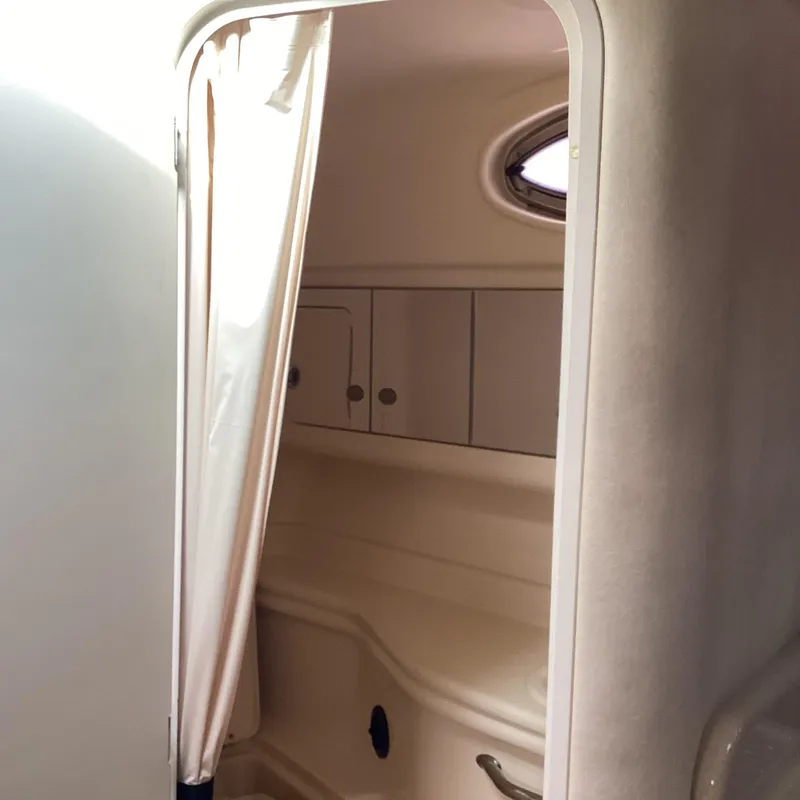 Slide: The Image of Interior cabin of 2005 Sea Ray 320 Sundancer with storage cabinets and porthole. - 25