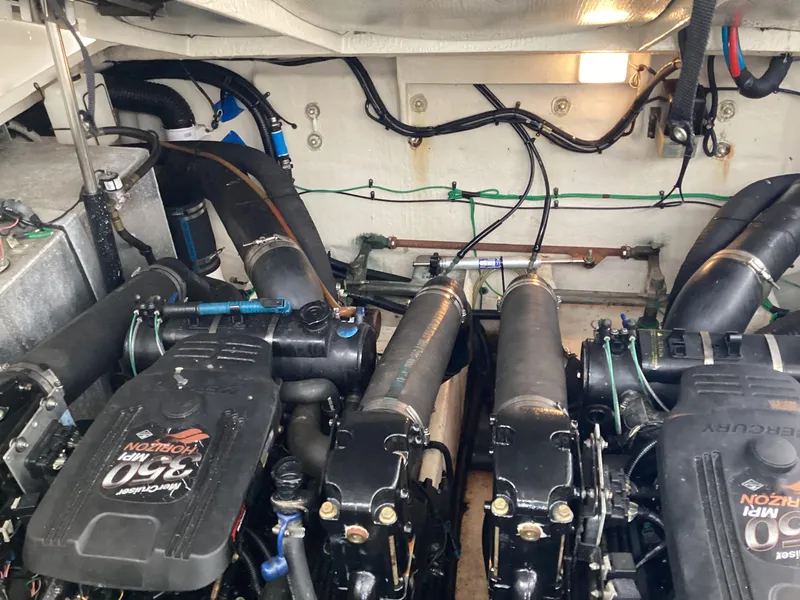 Slide: The Image of Engine room of 2005 Sea Ray 320 Sundancer with twin Mercury engines. - 26