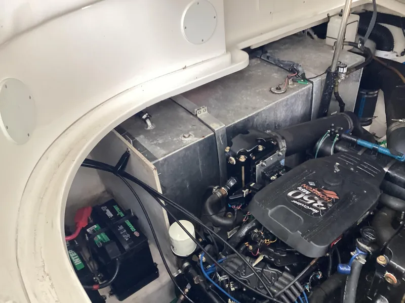 Slide: The Image of Engine compartment of 2005 Sea Ray 320 Sundancer, featuring batteries and mechanical components. - 27