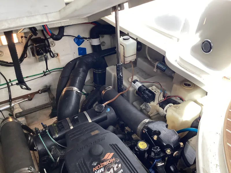 Slide: The Image of Engine compartment of 2005 Sea Ray 320 Sundancer boat, showcasing mechanical components. - 28